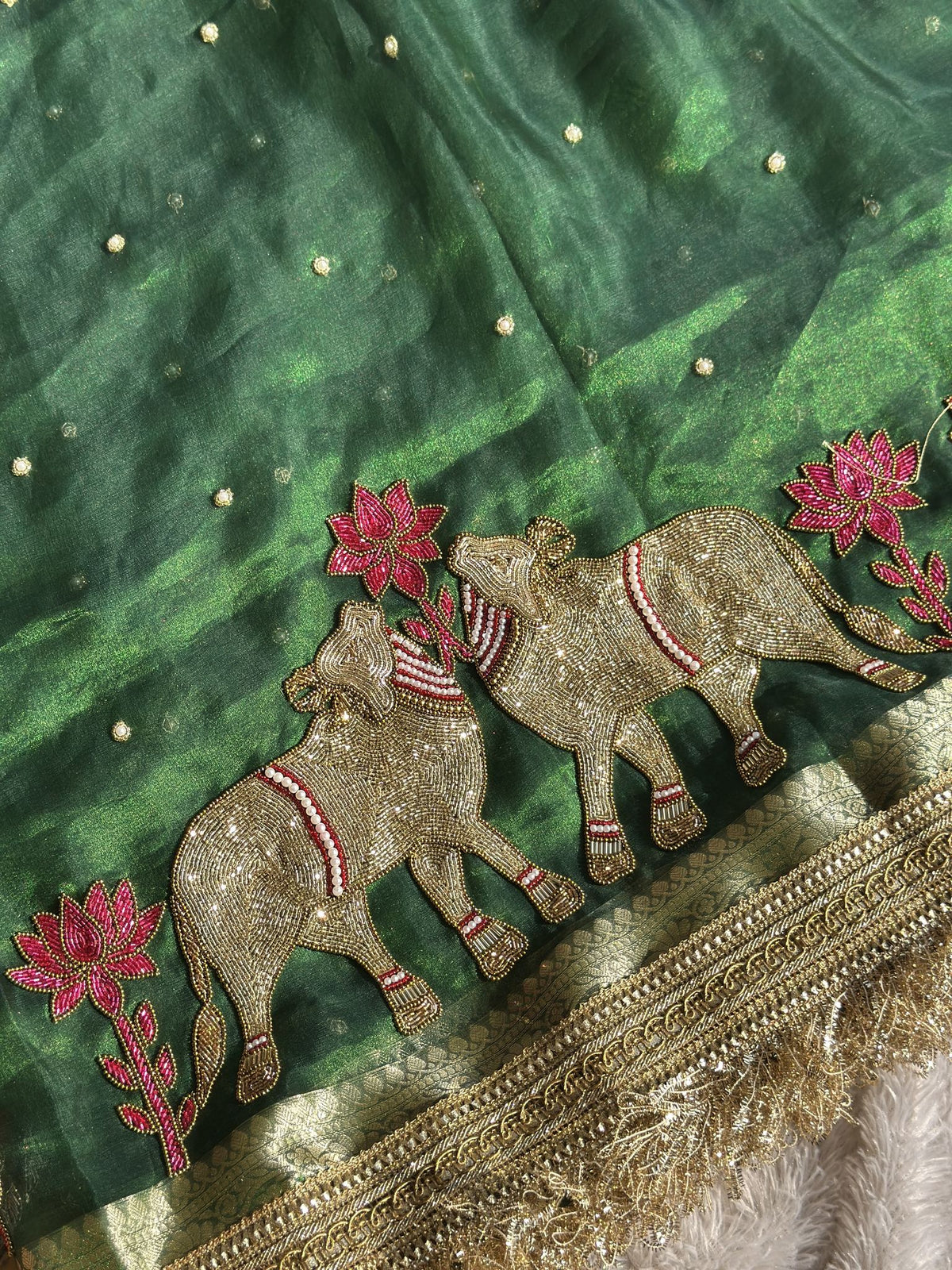 Gold zari elephants with pink lotus motifs on green Gajanandi saree