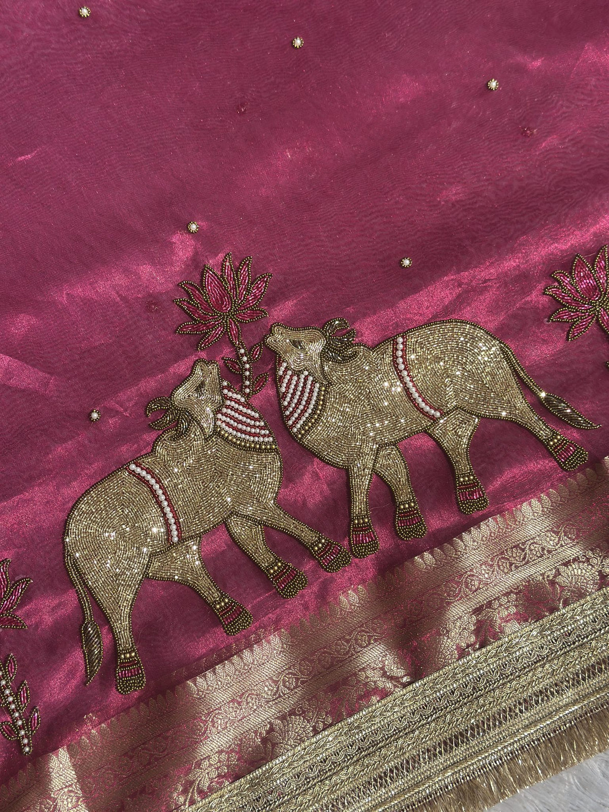 Close-up of gold zari elephant motif on Gajanandi dark pink saree