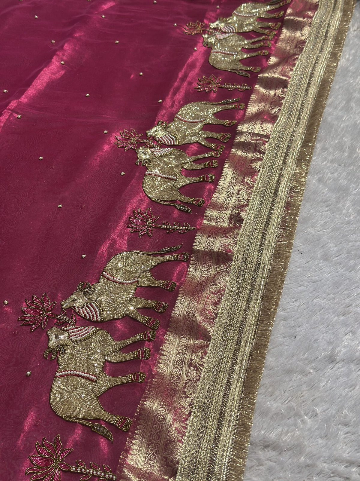 Zari border and elephant motif detail on dark pink Banarasi silk saree