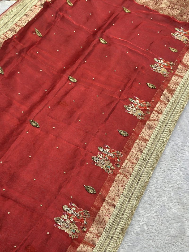 Red tissue saree body with zari leaf buttis and Ganesh Laxmi border motifs