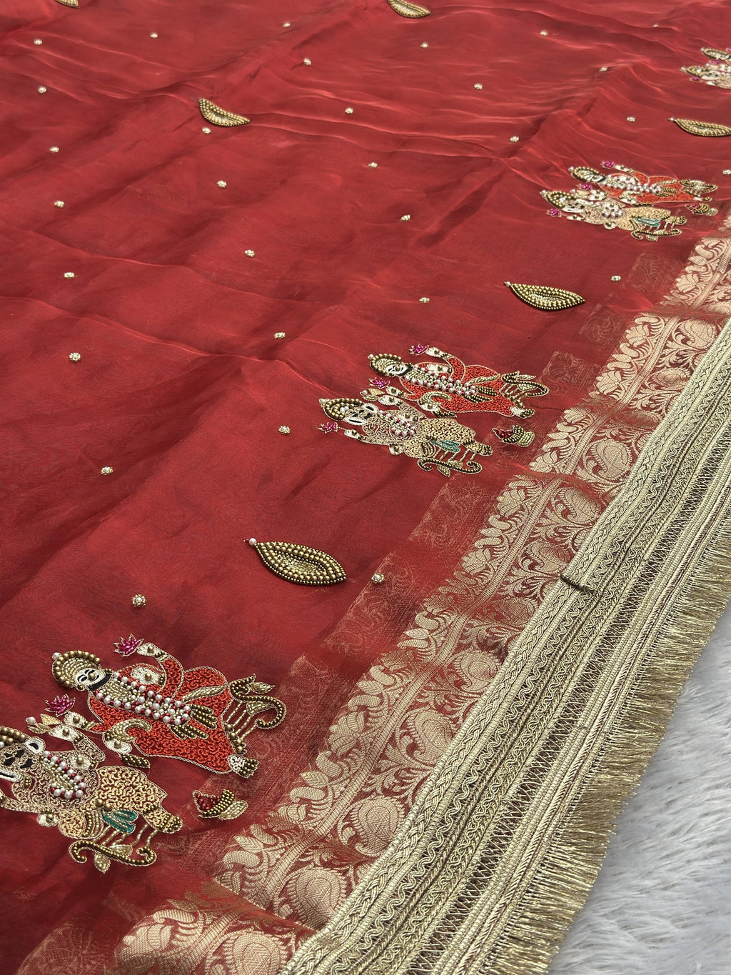 Ganesh Laxmi motif border with zari brocade edge on red tissue saree
