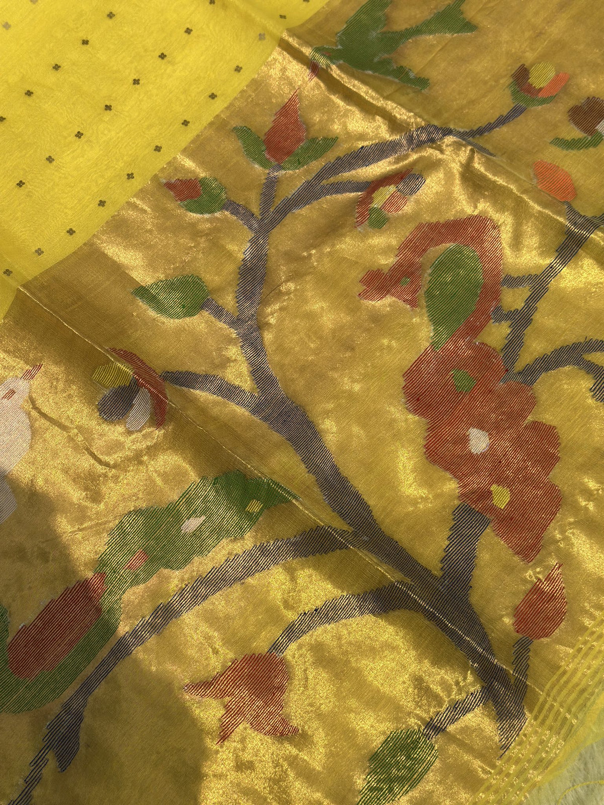 Woven flowering vine motif on golden yellow Jamdani pallu