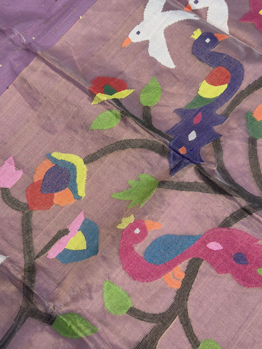 Close-up of colourful peacock and flowering vine on lavender Jamdani