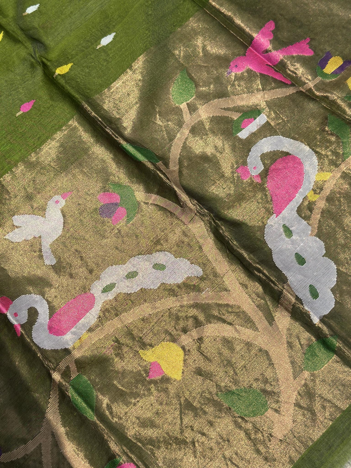 Close-up of woven bird and floral motifs on olive green Jamdani