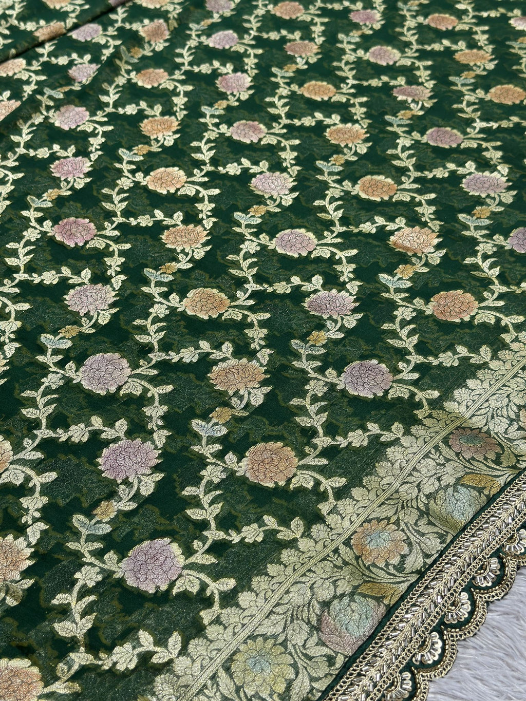 Gold zari detail on green khaddi georgette Banarasi saree