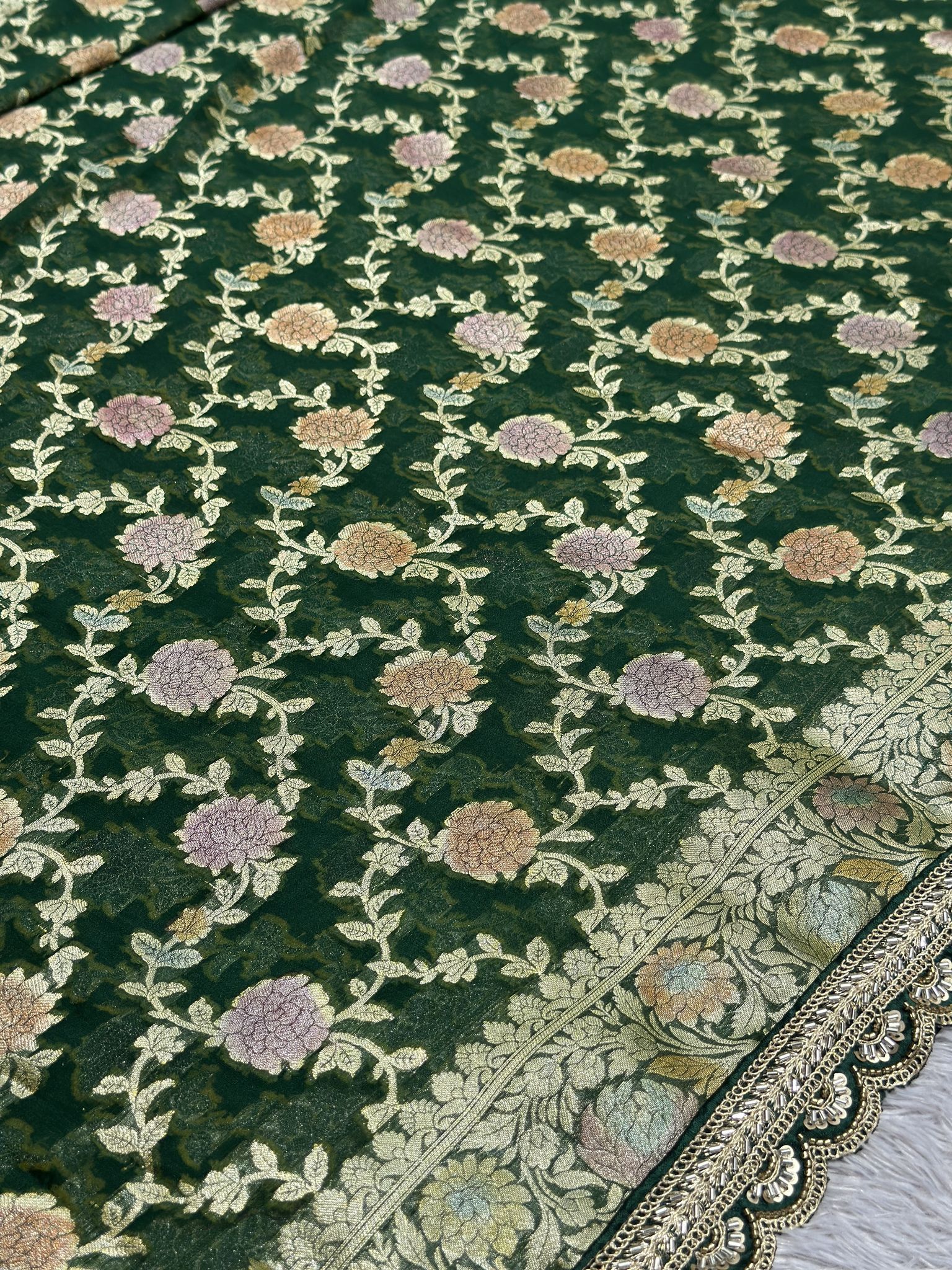 Gold zari detail on green khaddi georgette Banarasi saree
