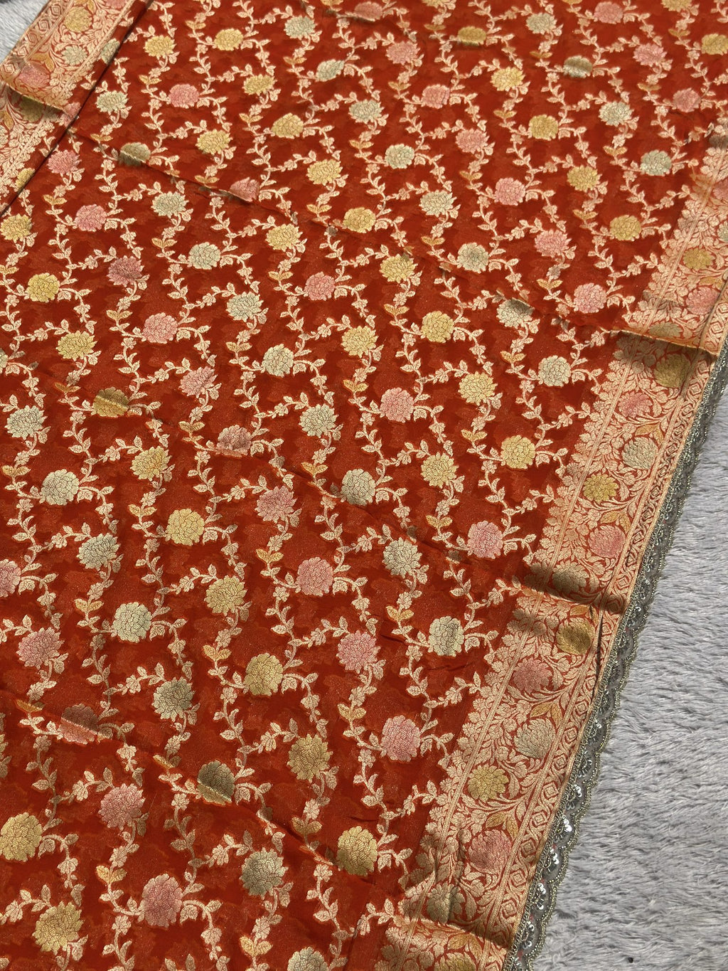 Allover zari floral jaal on rust orange Khaddi Georgette saree