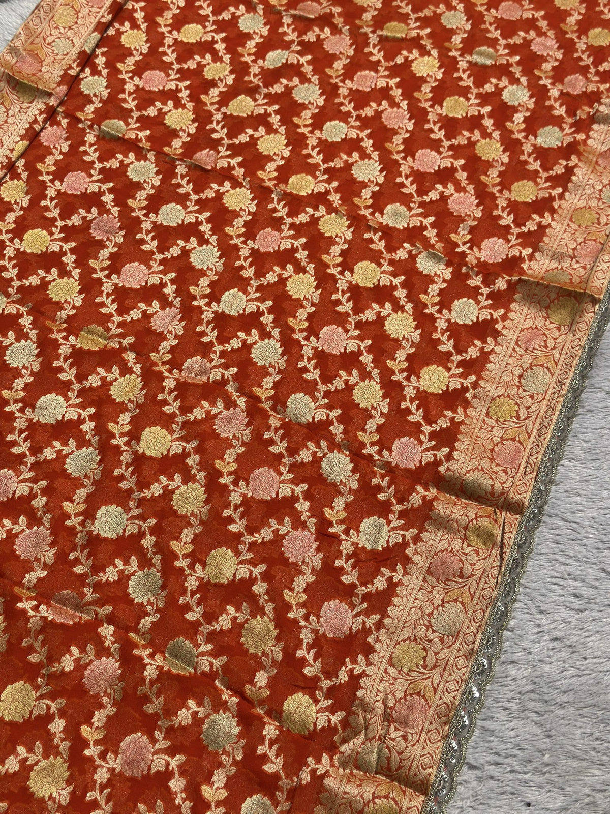 Allover zari floral jaal on rust orange Khaddi Georgette saree