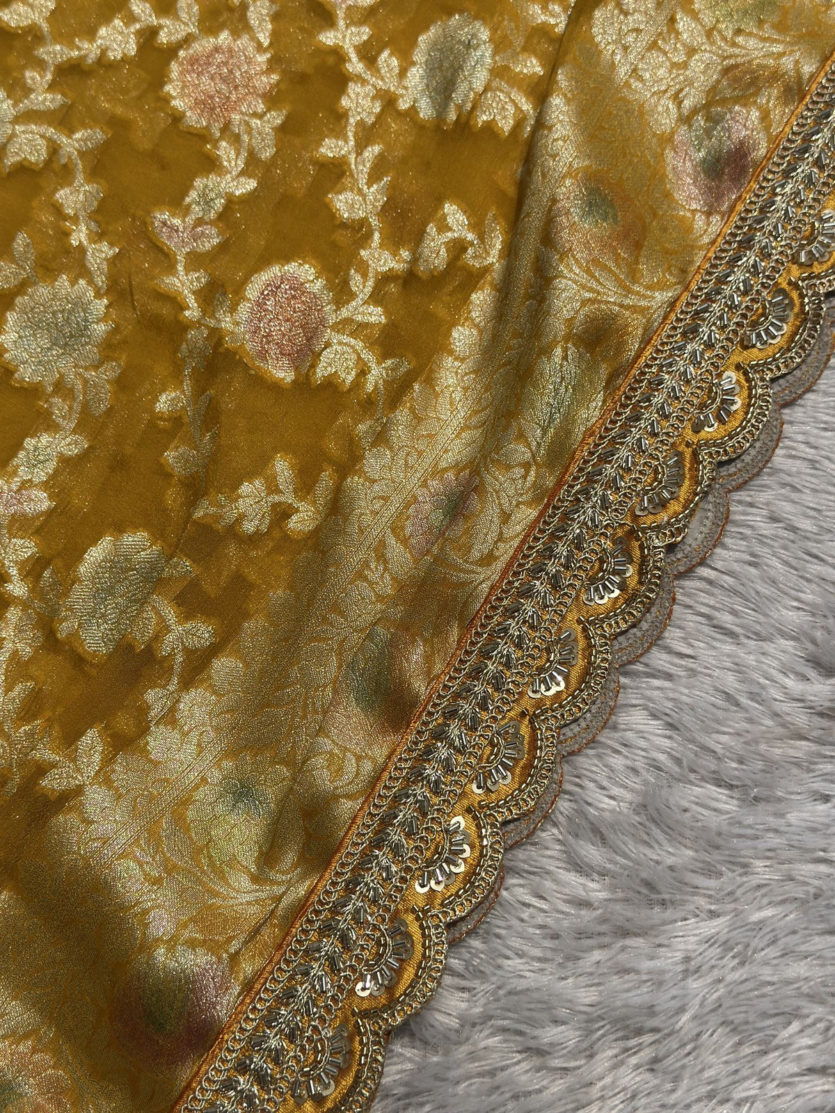 Embellished border detail on yellow Khaddi Georgette saree