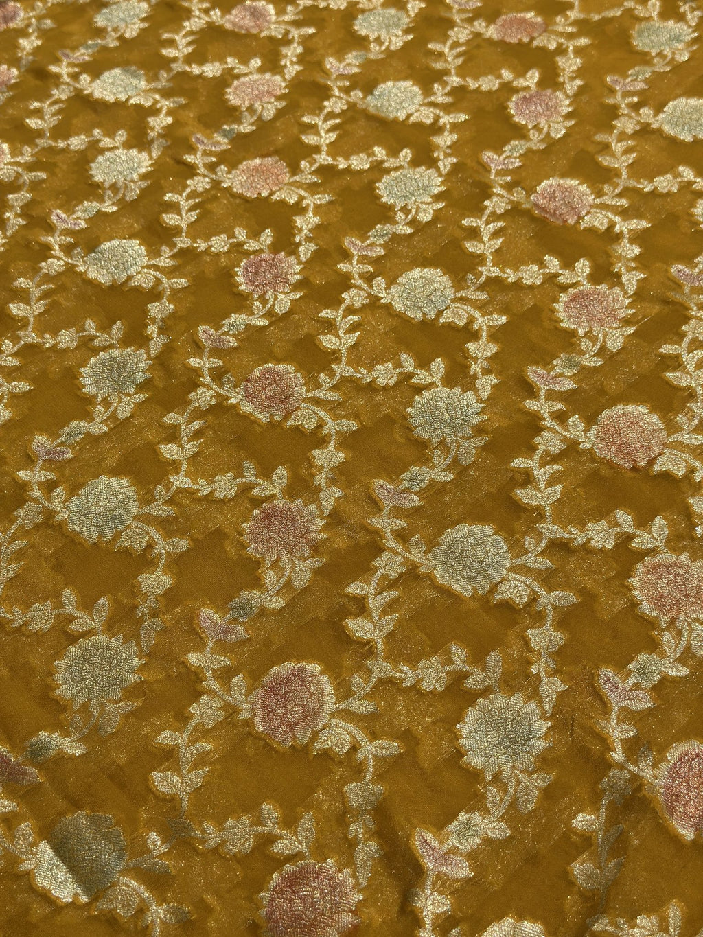 Close-up of woven floral motifs on yellow Khaddi Georgette