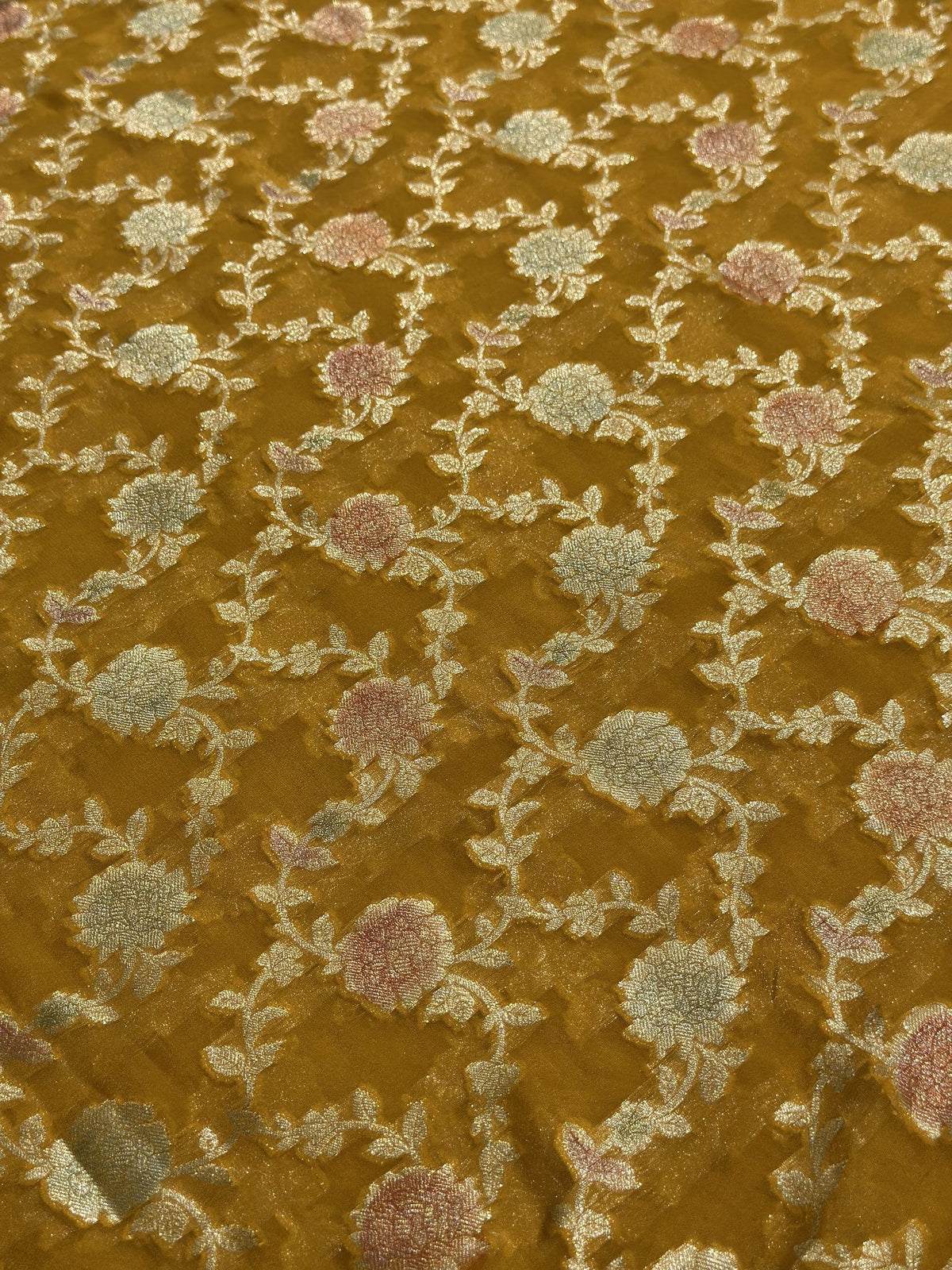 Close-up of woven floral motifs on yellow Khaddi Georgette