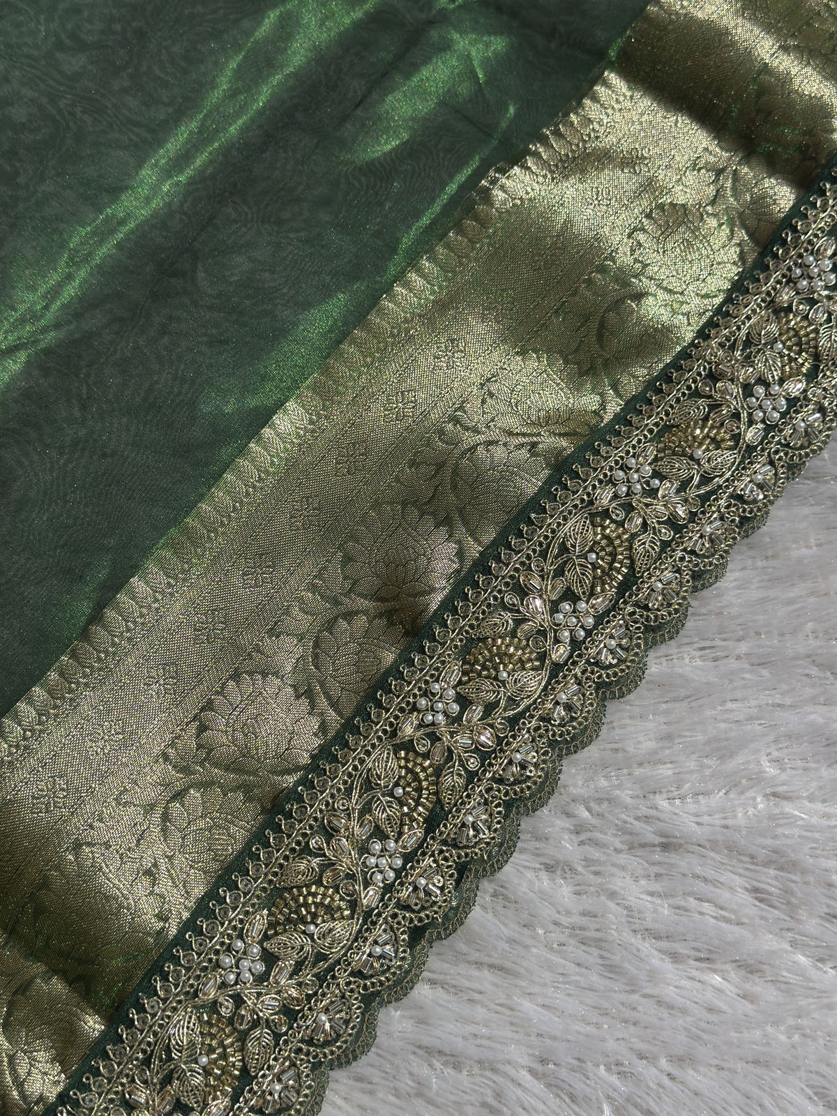 Scalloped embroidered edge and zari brocade border detail on Saundarya green saree