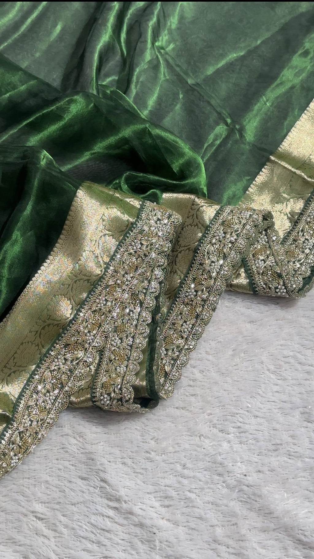 Close-up of embroidered scalloped border on green Banarasi tissue saree