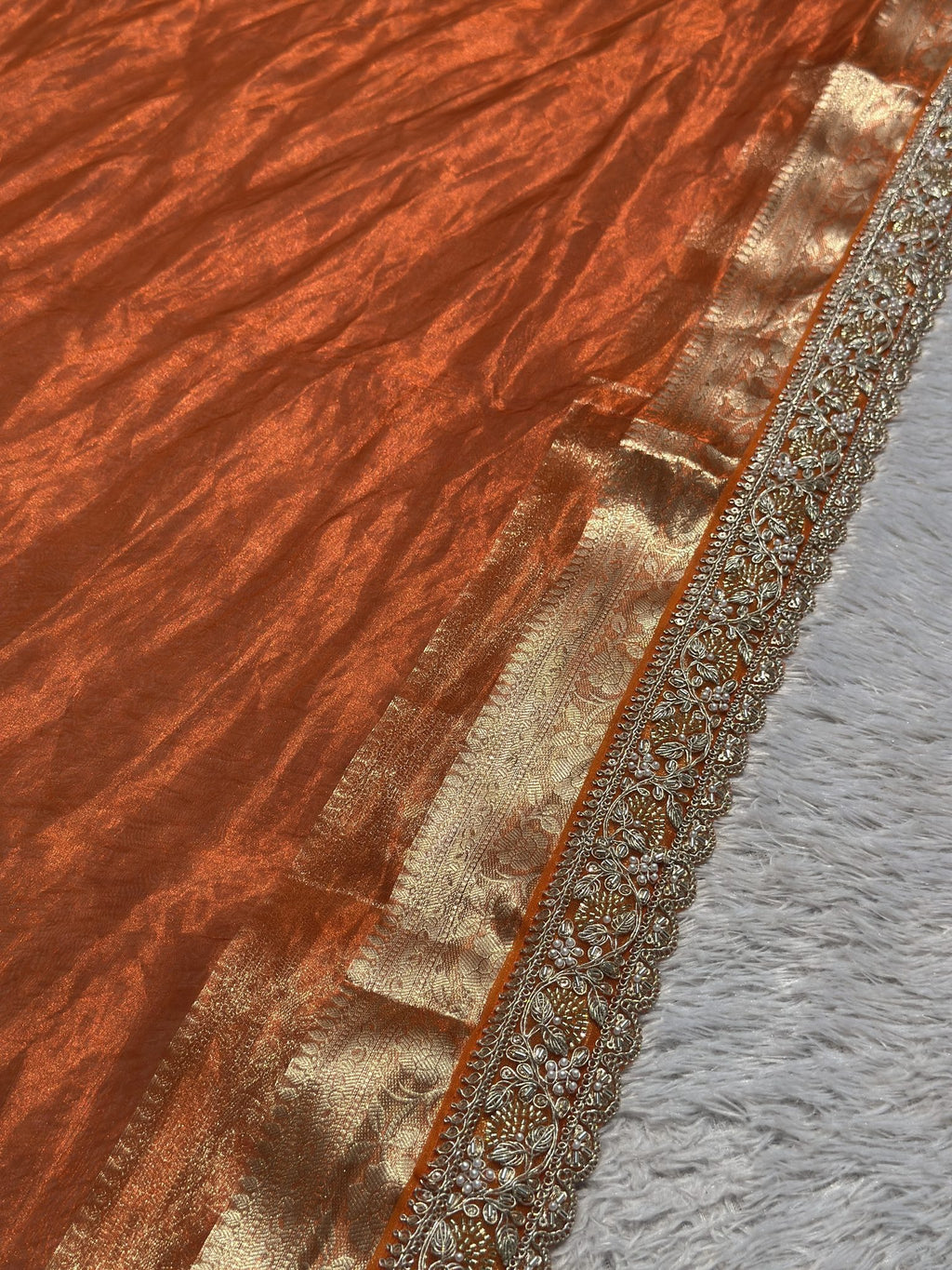 Gold zari border and scalloped embroidered edge on Saundarya orange saree