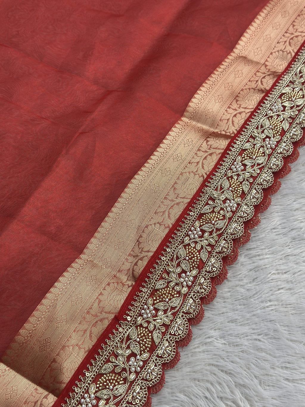 Scalloped embroidered edge and zari brocade border on Saundarya red saree