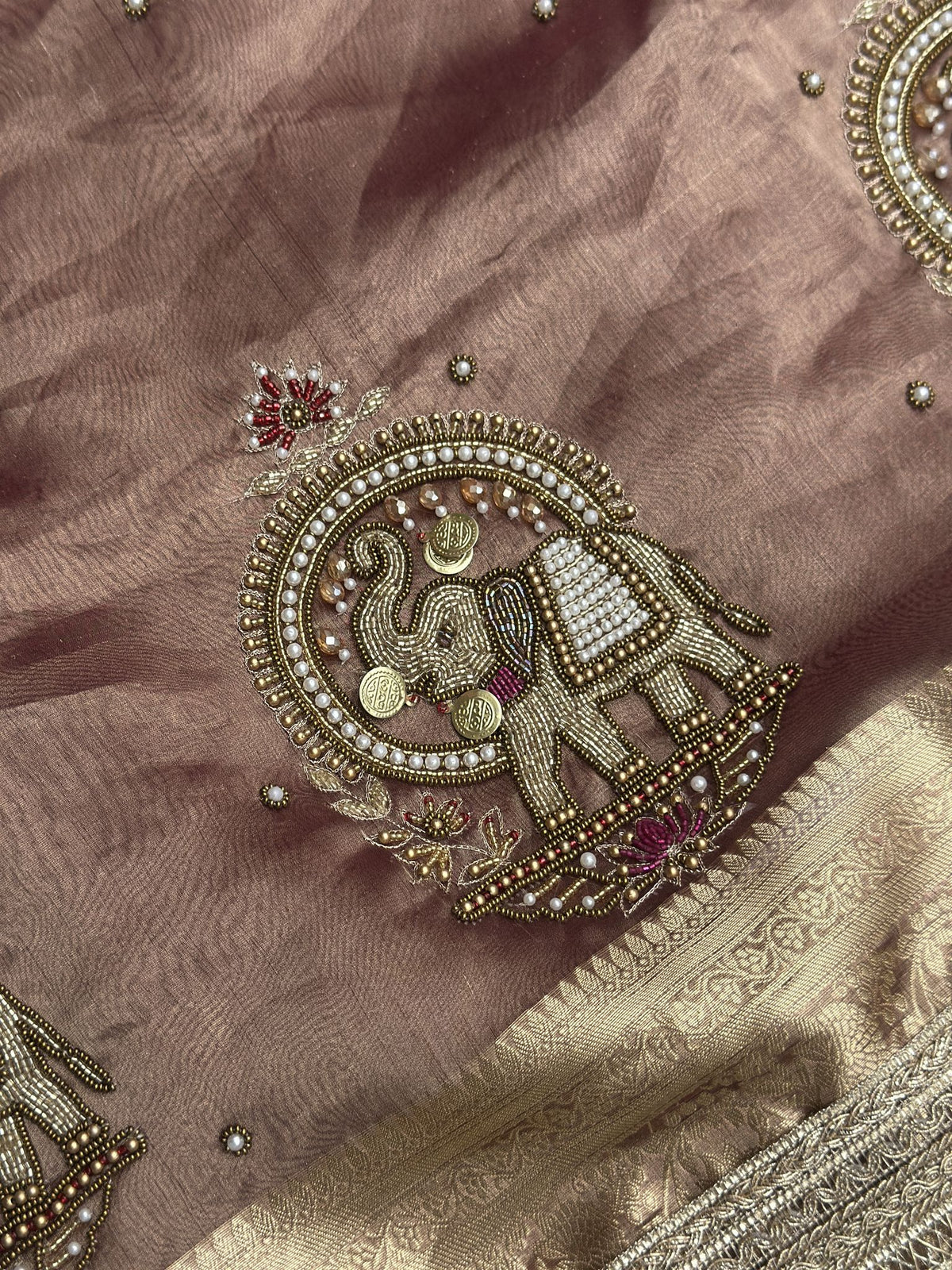 Gold zari elephant motif close-up on Shahi Gajraj copper brown saree