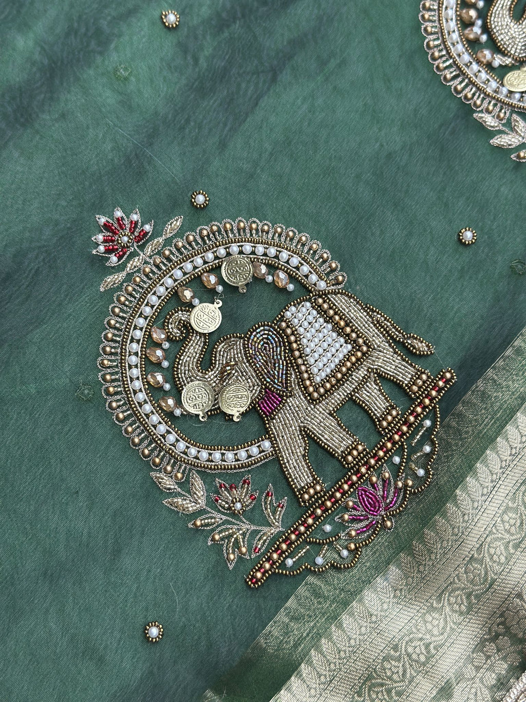 Gold zari elephant motif detail on Shahi Gajraj Green saree