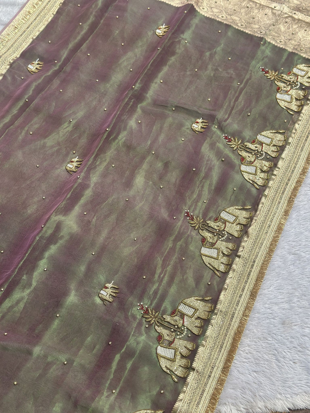 Mauve and green shot tissue saree body with golden elephant motifs