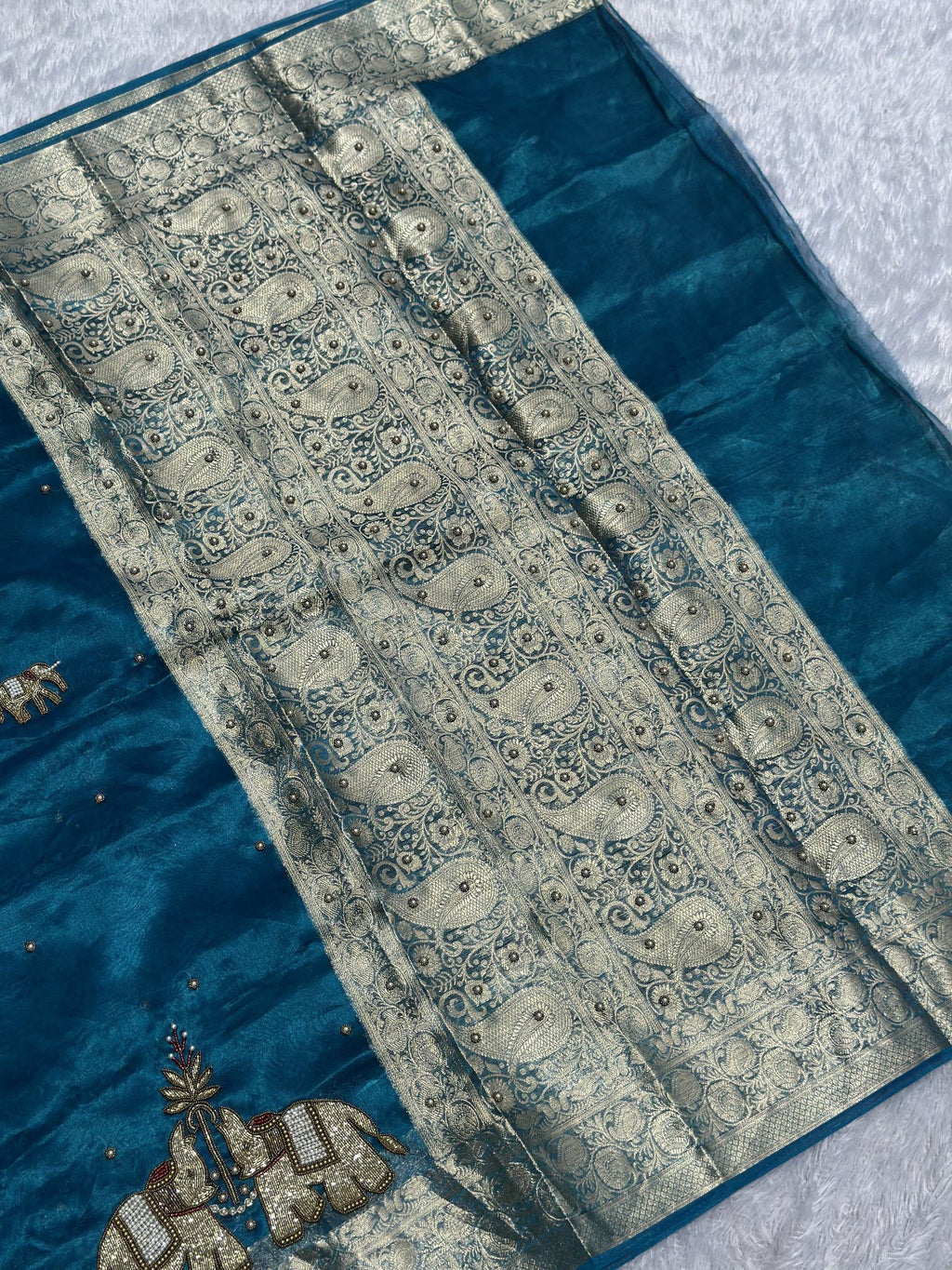 Suvarna Hatti teal blue Banarasi tissue saree with golden elephant motifs