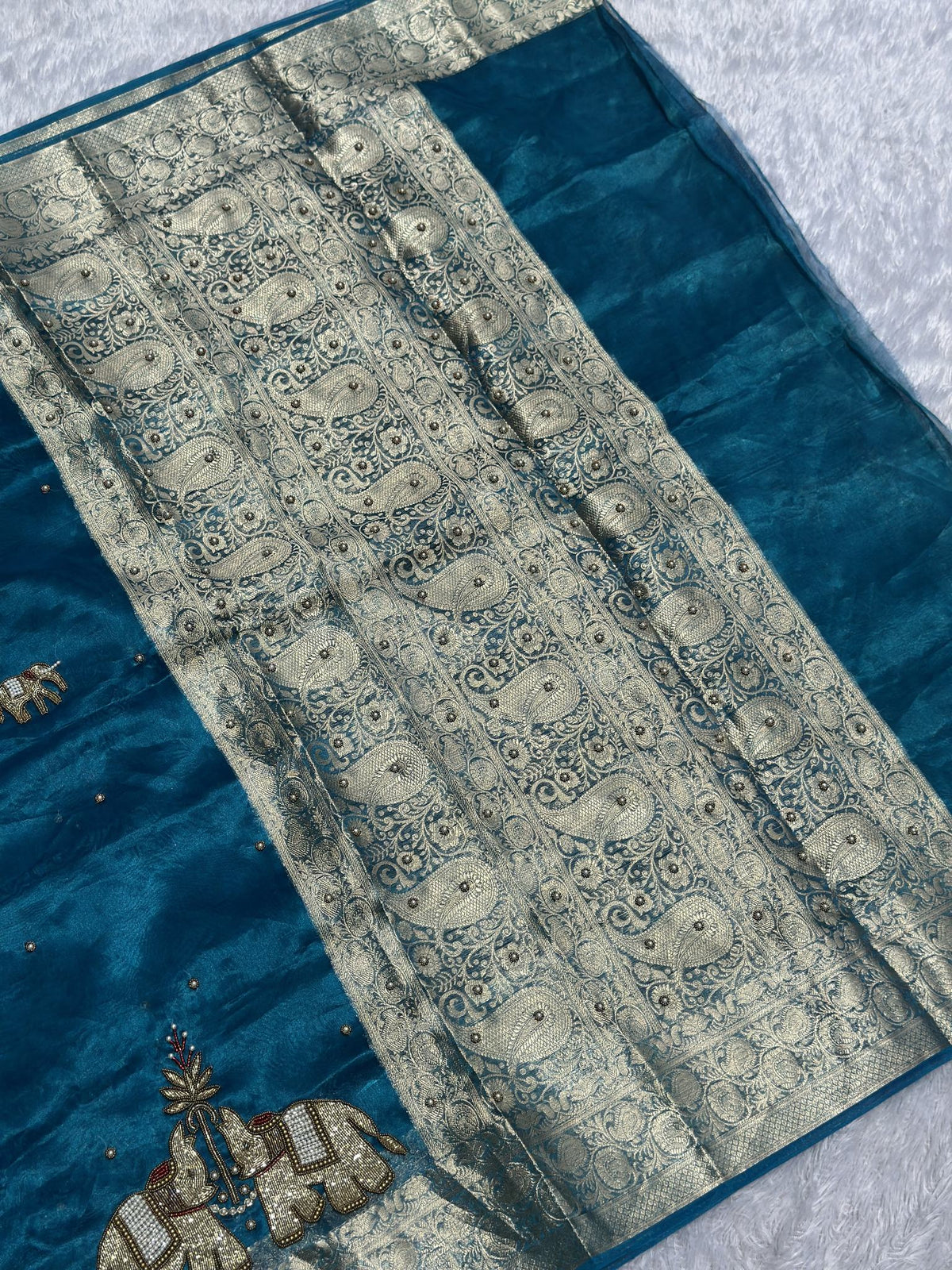 Suvarna Hatti teal blue Banarasi tissue saree with golden elephant motifs