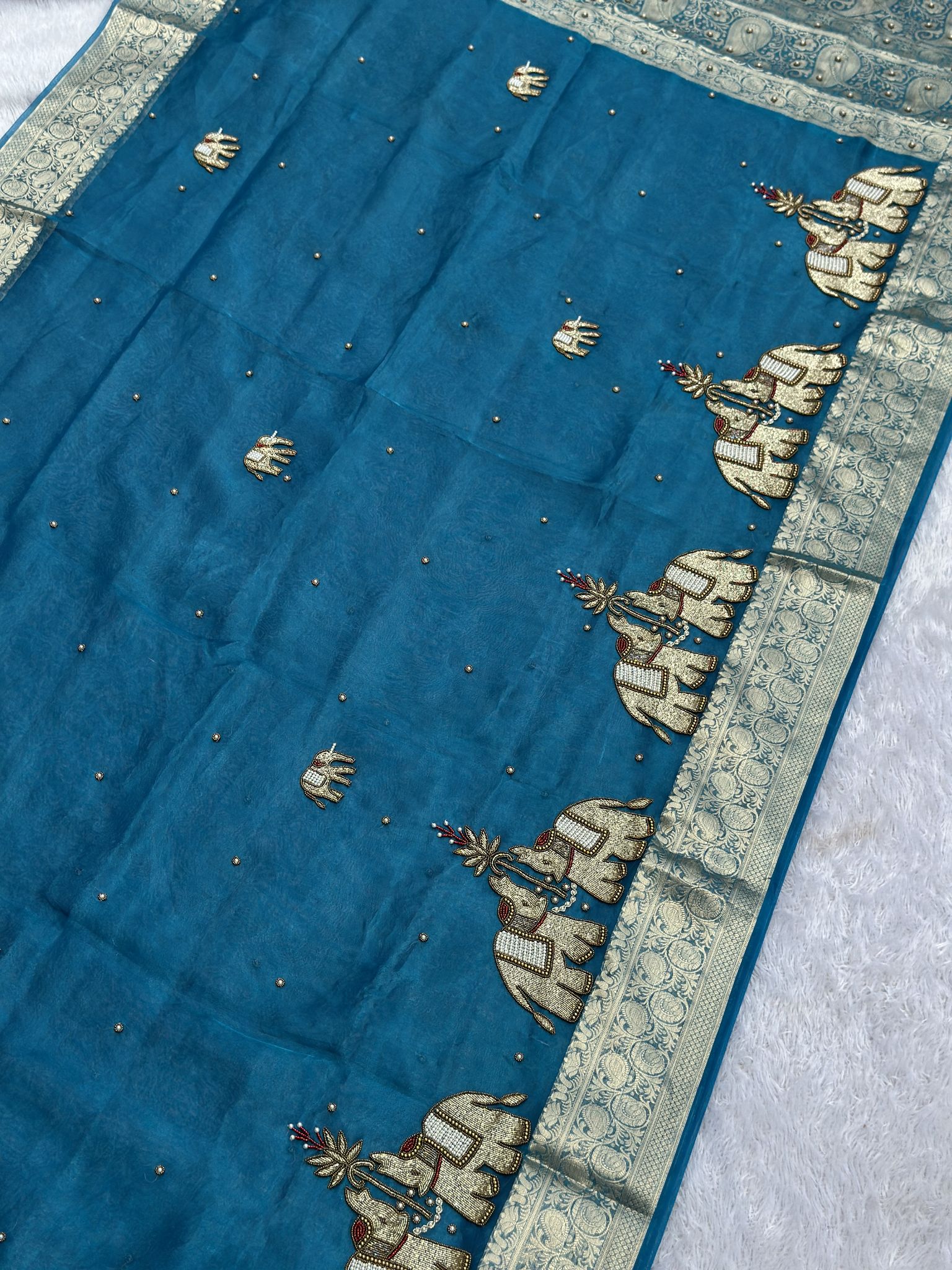 Teal blue Banarasi tissue saree draped, Suvarna Hatti elephant weave