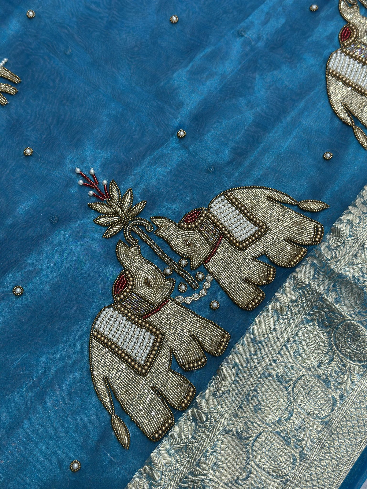 Gold zari elephant motif close-up on Suvarna Hatti teal blue saree